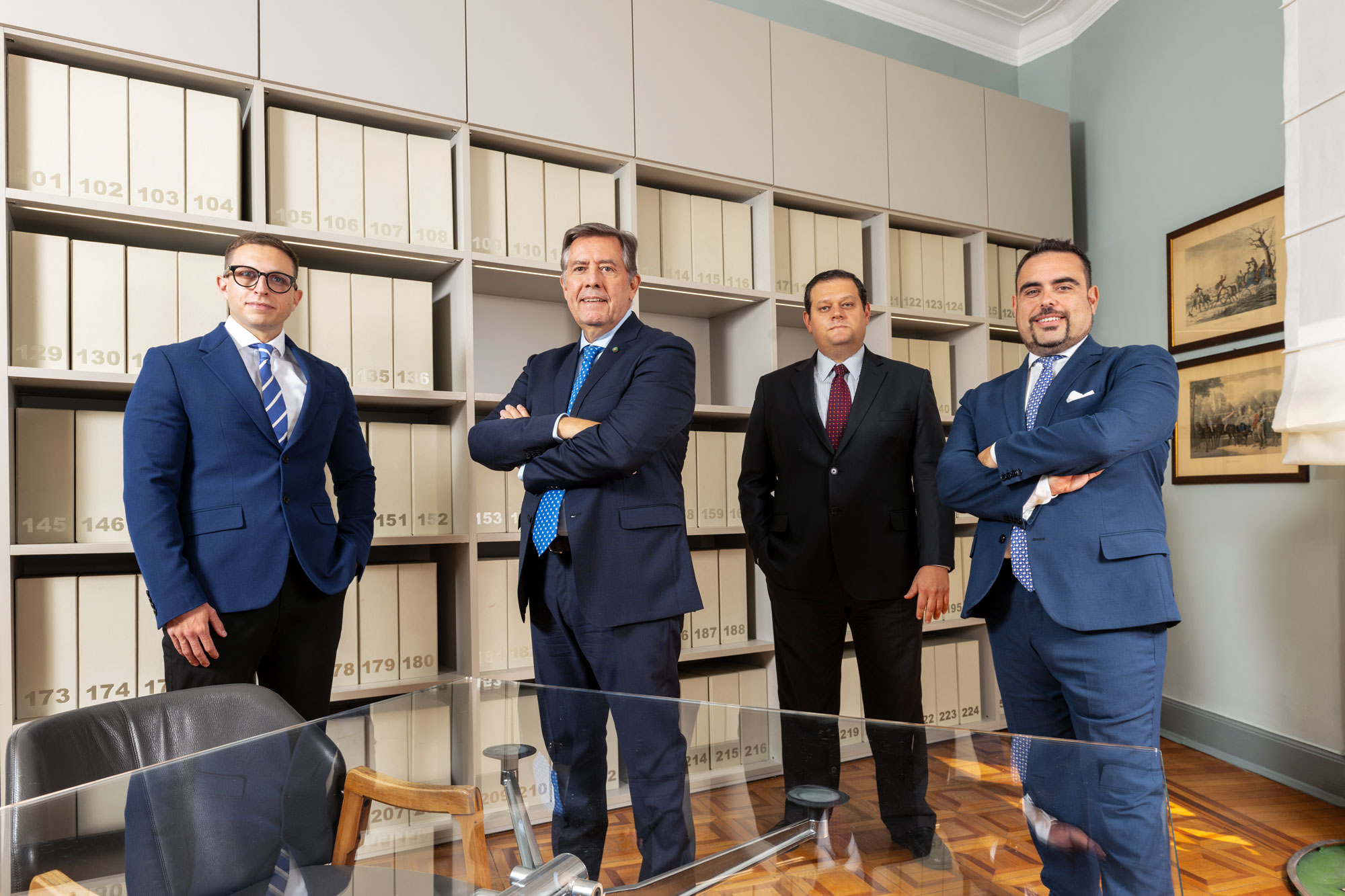 Four PMP professionals in front of the archive at the Milan office